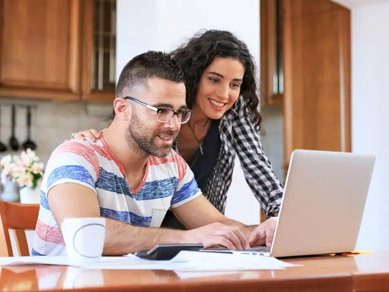 Smiling couple with laptop