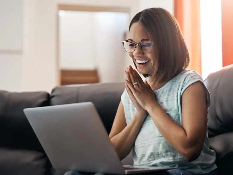 Smiling woman looking at laptop